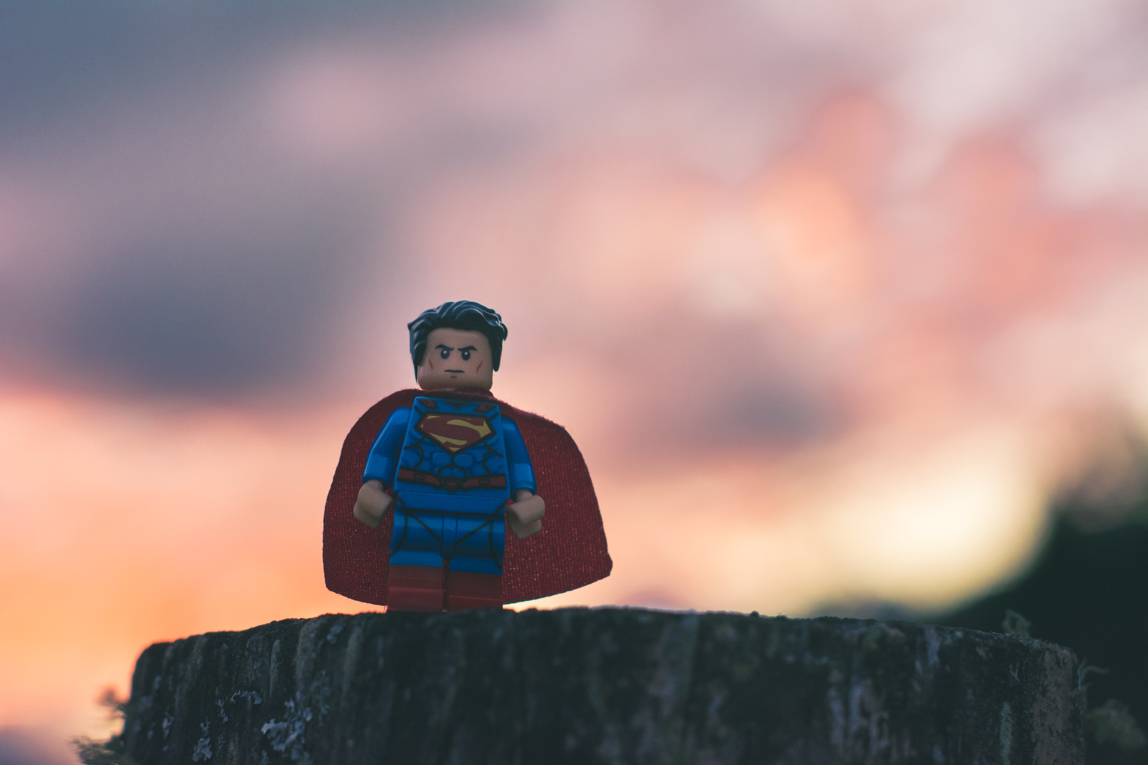 Why TripLeaders are our Superheroes with a Lego Superman figurine standing in front of a sunset.