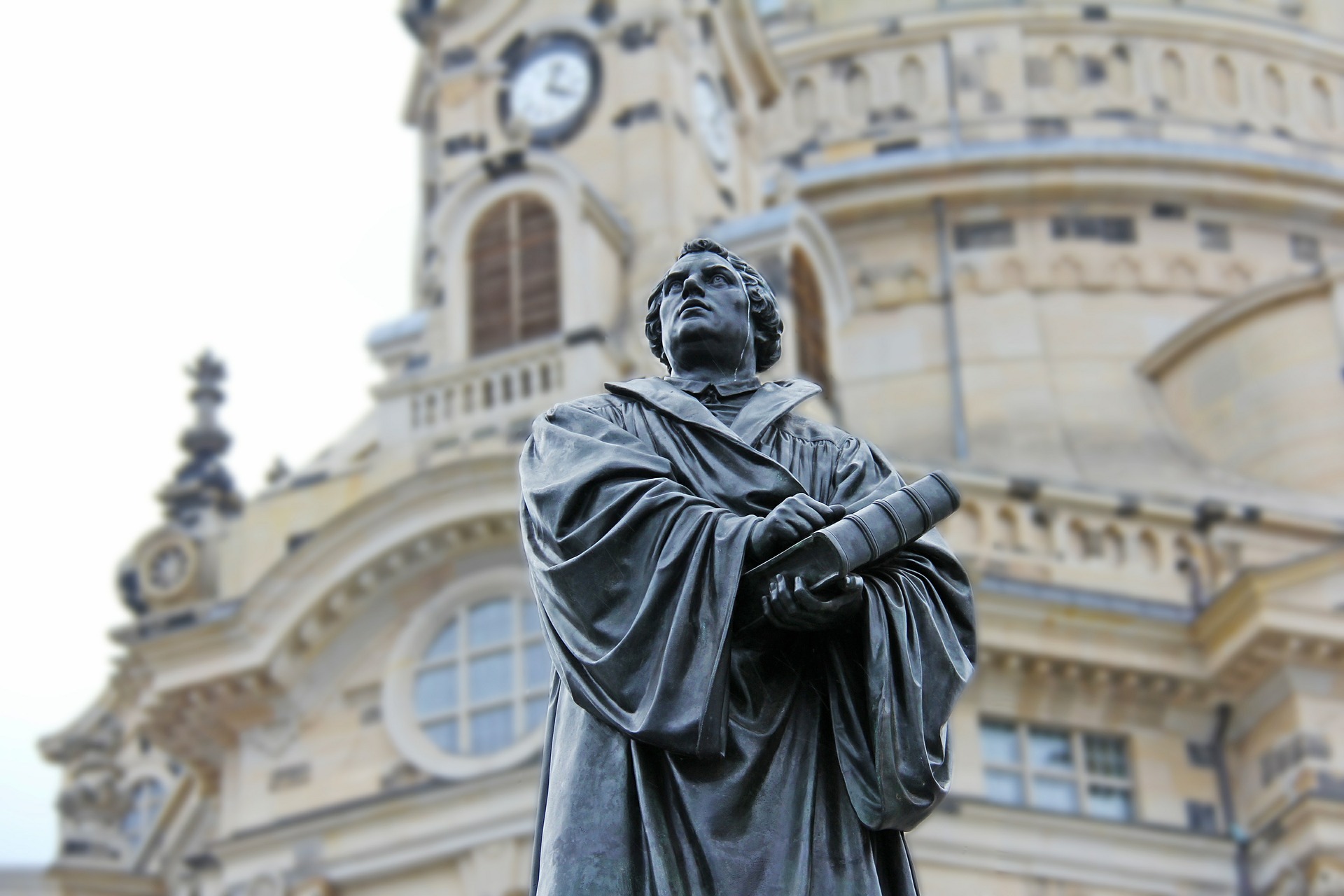 A statue of Martin Luther in front of a church in Germany